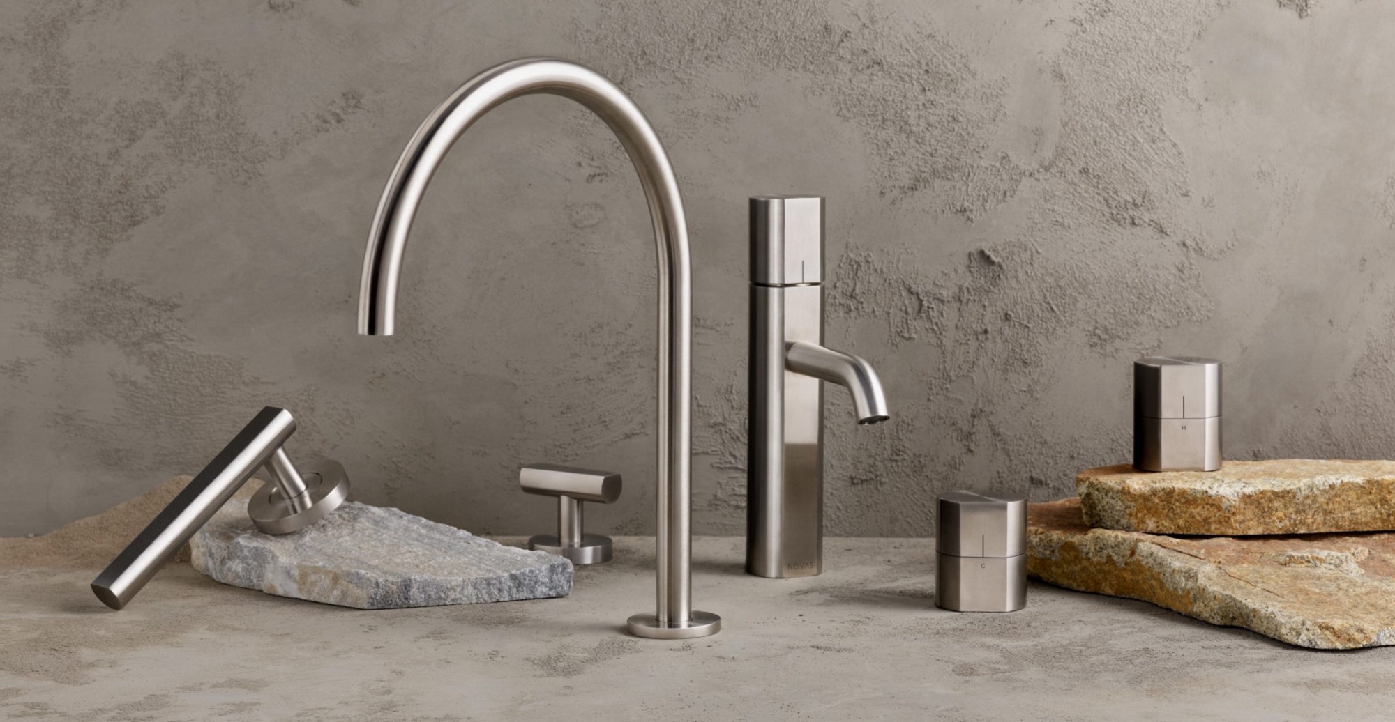 Prime collection basin set in satin stainless steel on a stone bench